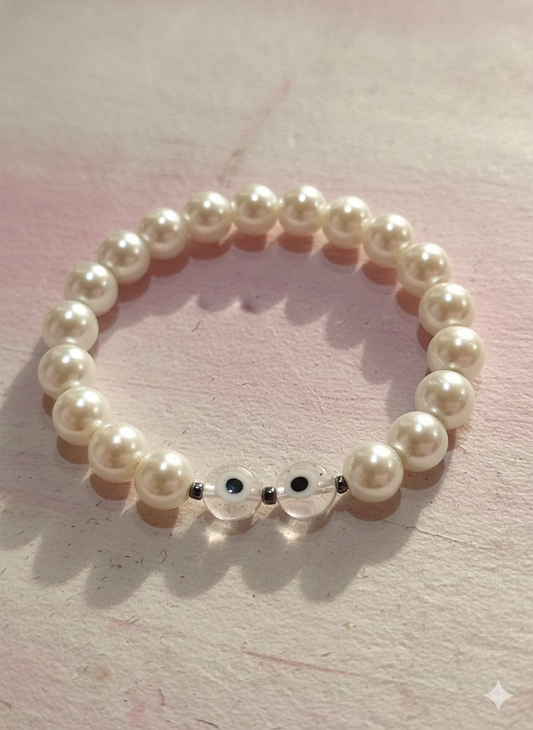 Pulsera perlas y dos ojos